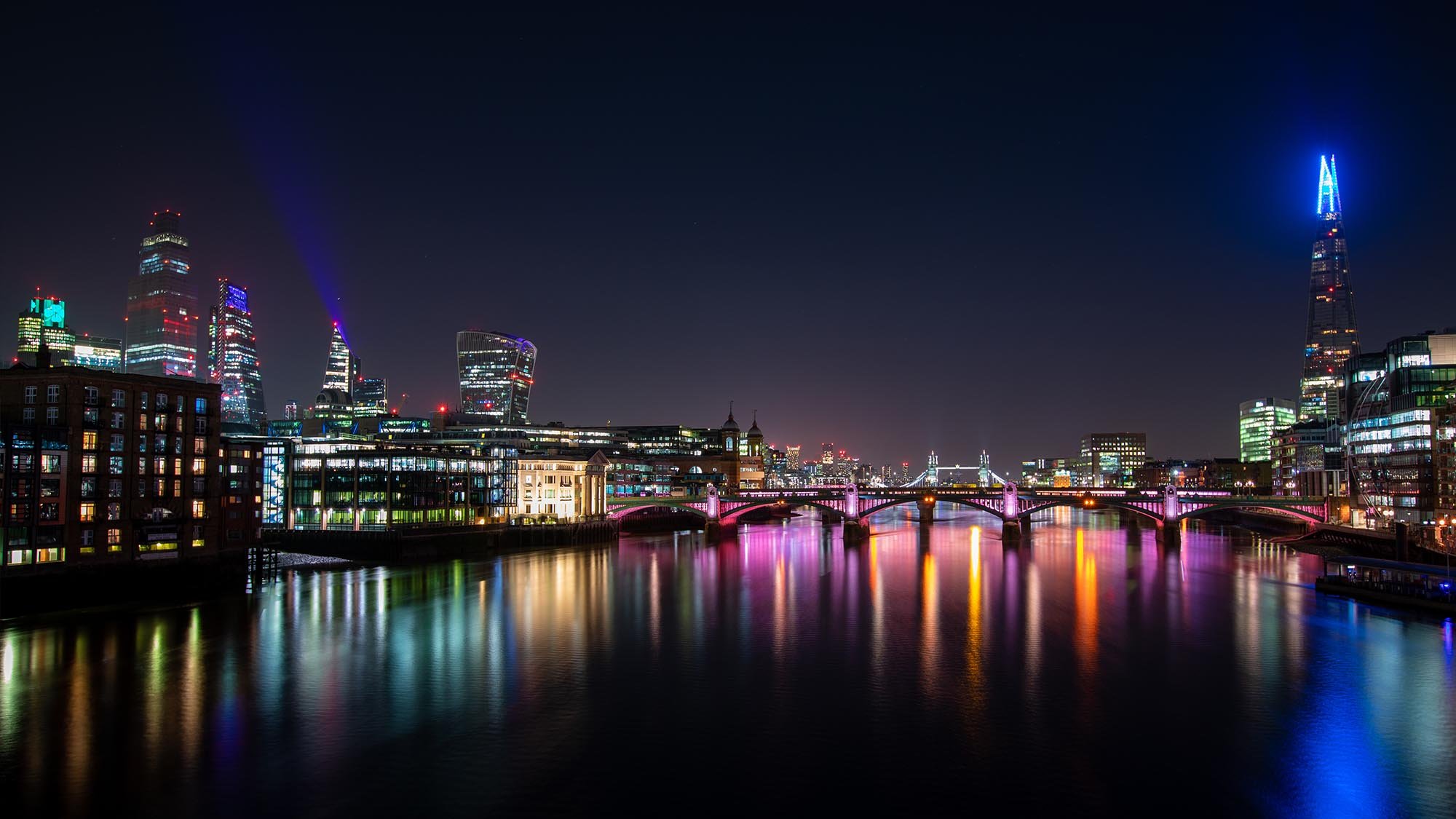 London city lights at night reflecting in the Thames.