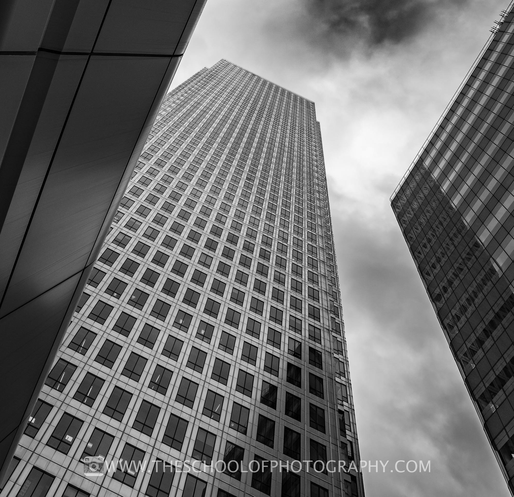 black and white skyscrapers against a cloudy sky